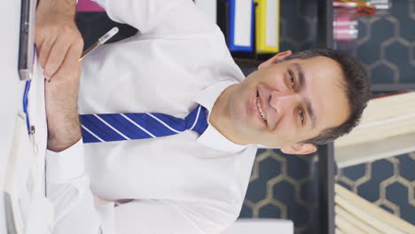 Vertical-video-of-Happy-and-peaceful-businessman-talking-to-camera.